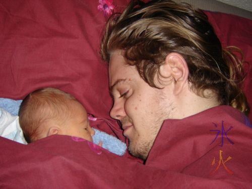 dad and newborn baby napping