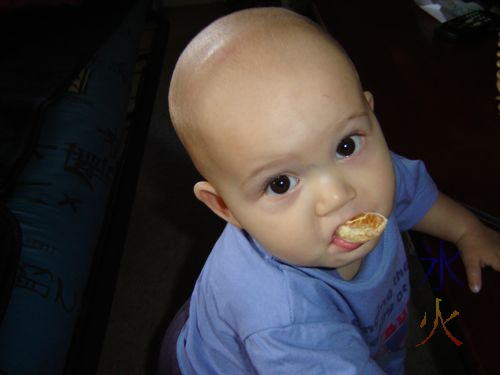 baby eating mandarin slice