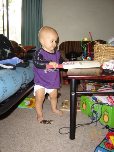 baby playing with cricket bat