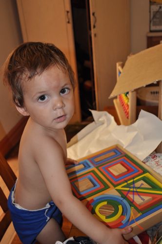 1yo with his nesting blocks and abacus from Eco Toys