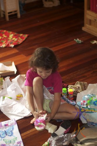 Very Small Small Girl opening Christmas presents