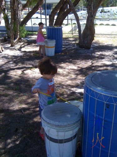 5yo and 3yo on the drums during a Child's Play Music session at Learning Hub