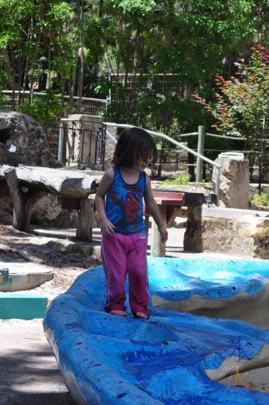 Toddler playing in the water course at Perth Zoo