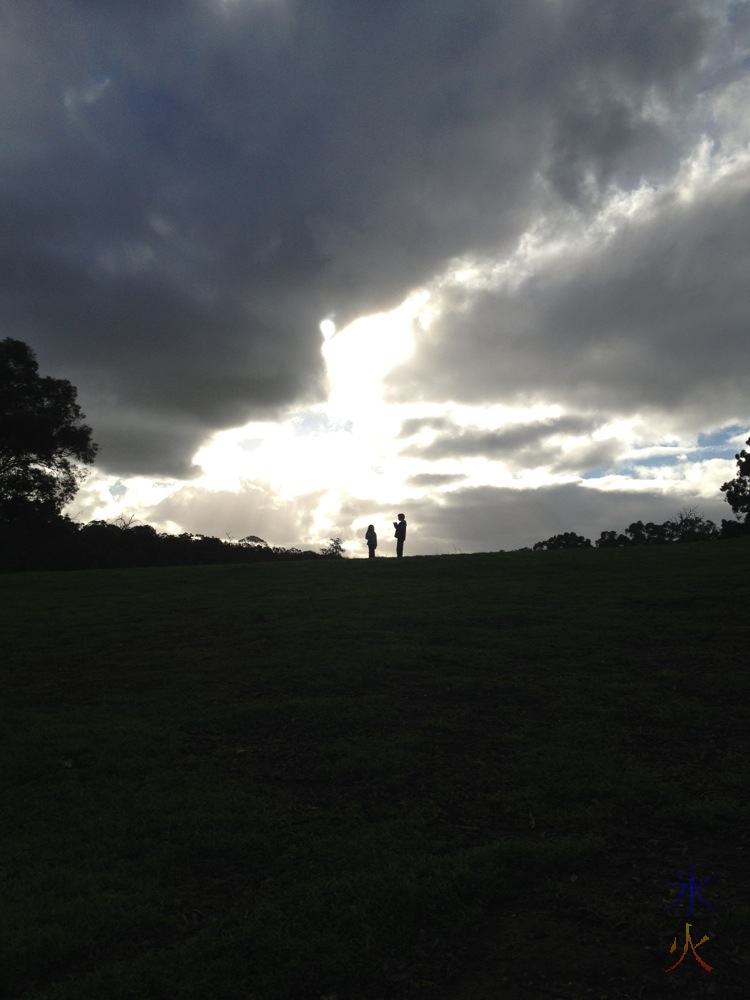 kids silhouetted on top of a hill