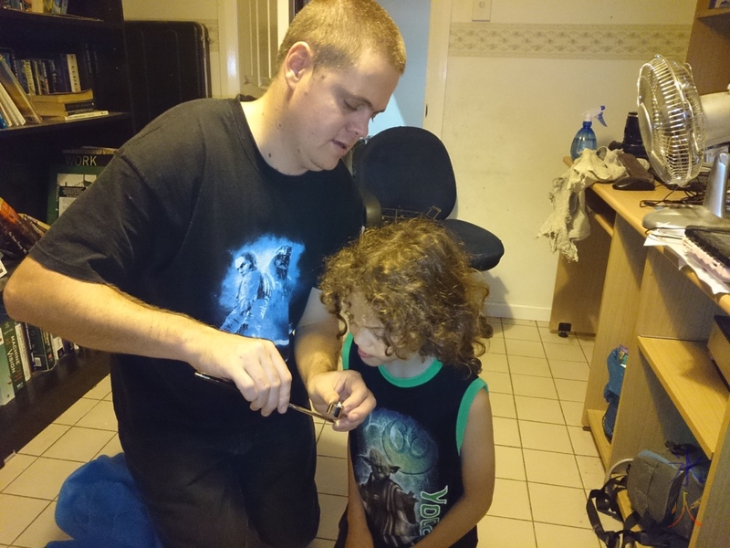 Examining the edge on a straight razor with a jeweller's glass