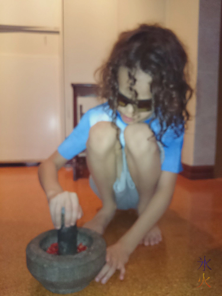 Pounding chilli padi for sambal belacan Pounding chilli padi for sambal belacan