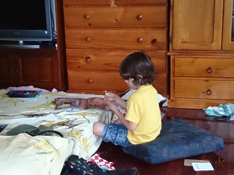 5yo putting together cardboard dinosaurs