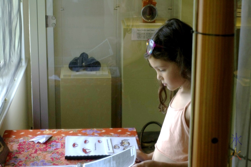 Looking at a photobook in Tai Jin House Museum, Christmas island, Australia