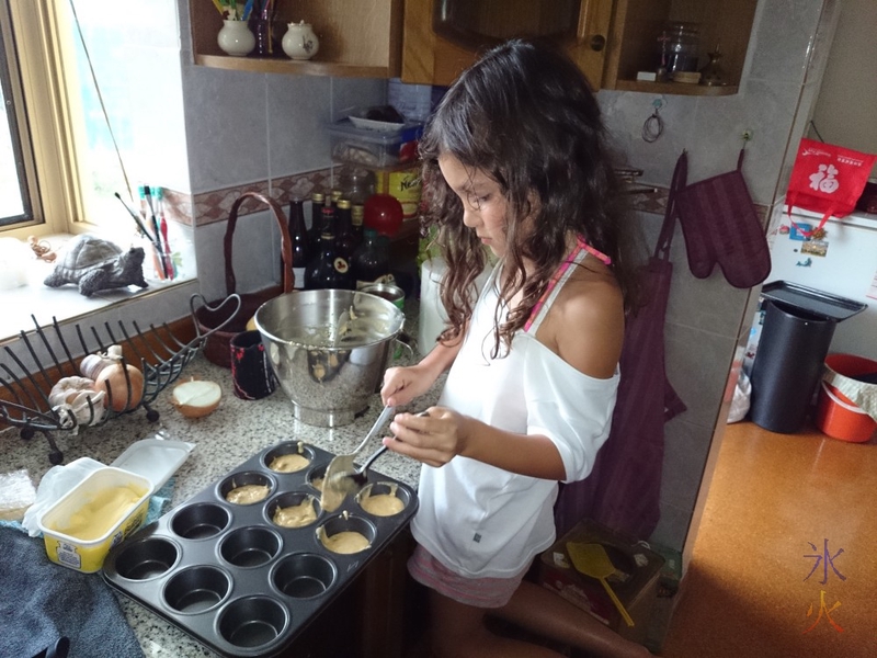 8yo helping Nanny make cupcakes