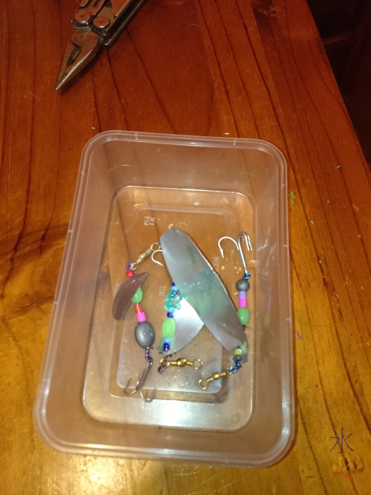 Container of fishing lures, one made by each child