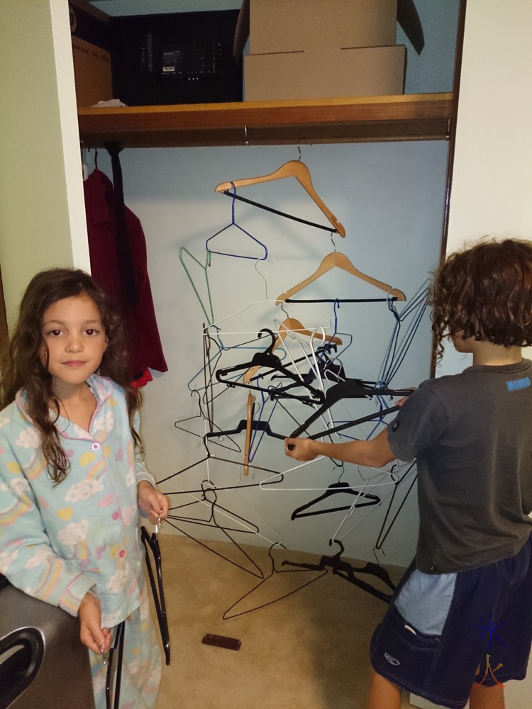 10yo and 8yo making a coathanger sculpture.  Balancing was hard apparently.