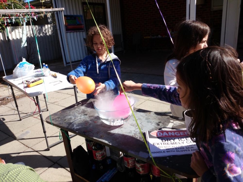 10yo and 8yo sticking balloons into dry ice