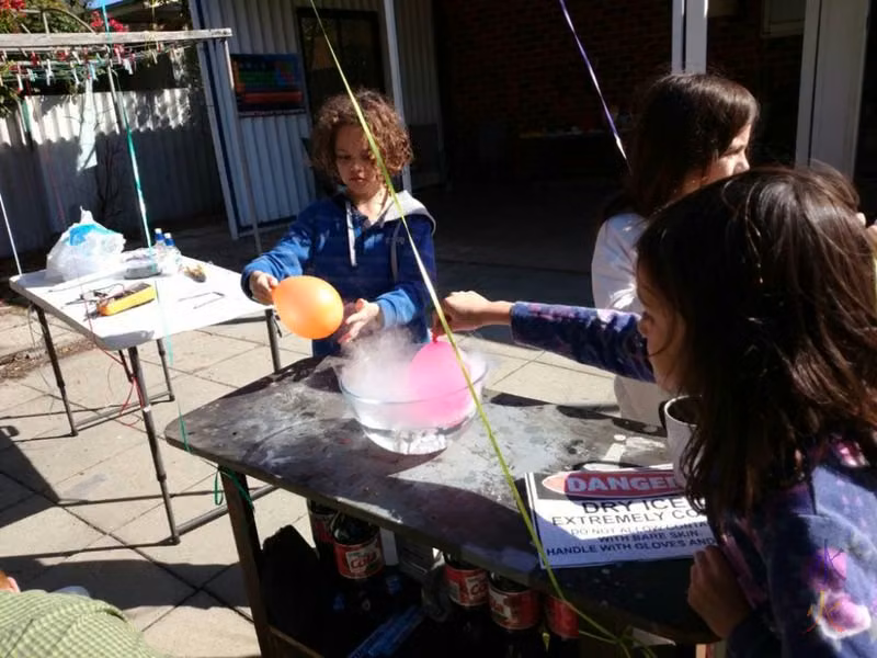10yo and 8yo sticking balloons into dry ice