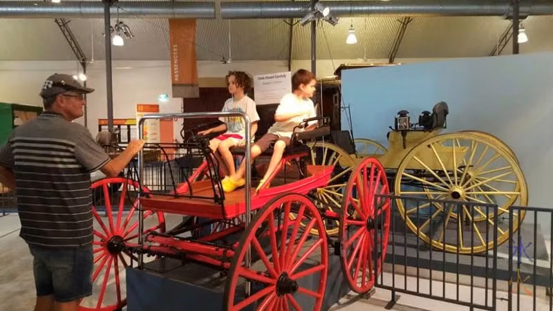 Sitting in a horse cart at the transport museum in Whiteman Park, Western Australia