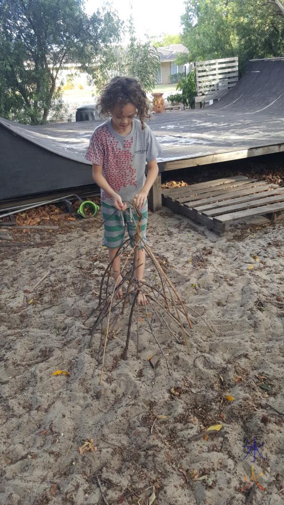 11yo building a campfire structure