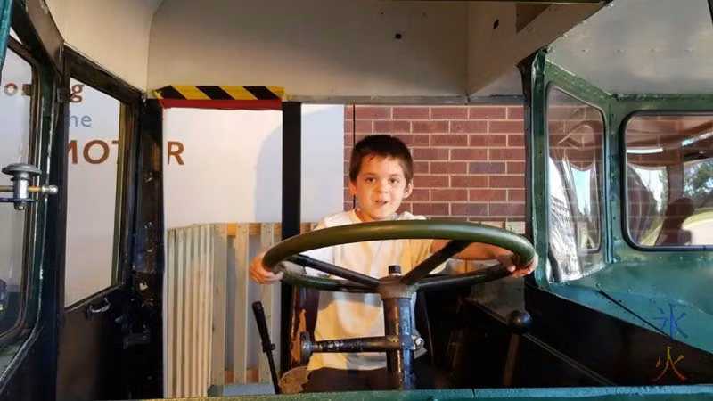7yo being entirely too gleeful playing in the section of old bus at the transport museum at Whiteman Park, Western Australia