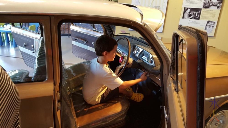 7yo playing in old car at the transport museum at Whiteman Park, Western Australia