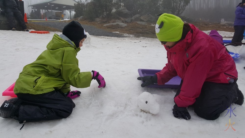 Sprat and 9yo building snow turtle, Lake Mountain, Victoria, Australia