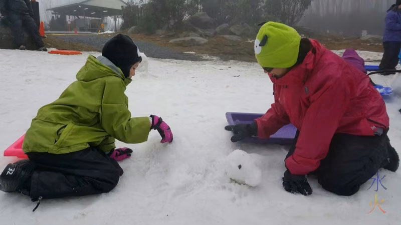 Sprat and 9yo building snow turtle, Lake Mountain, Victoria, Australia