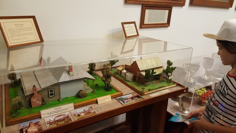 10y admiring models of cottages, Azelia Ley Homestead, Hamilton Hill, Western Australia