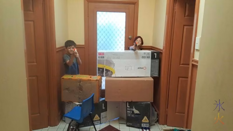 Kids fending off imaginary zombies from box fort