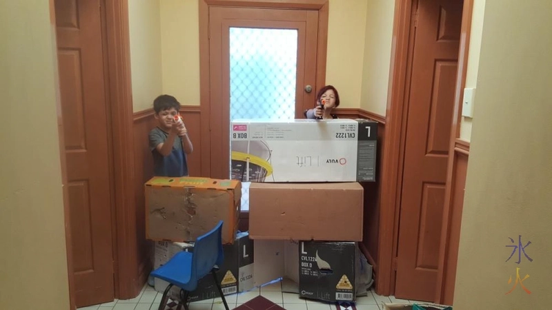 Kids fending off imaginary zombies from box fort