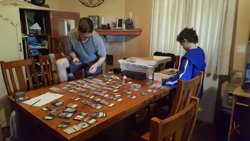 Big boys sorting through Magic The Gathering cards