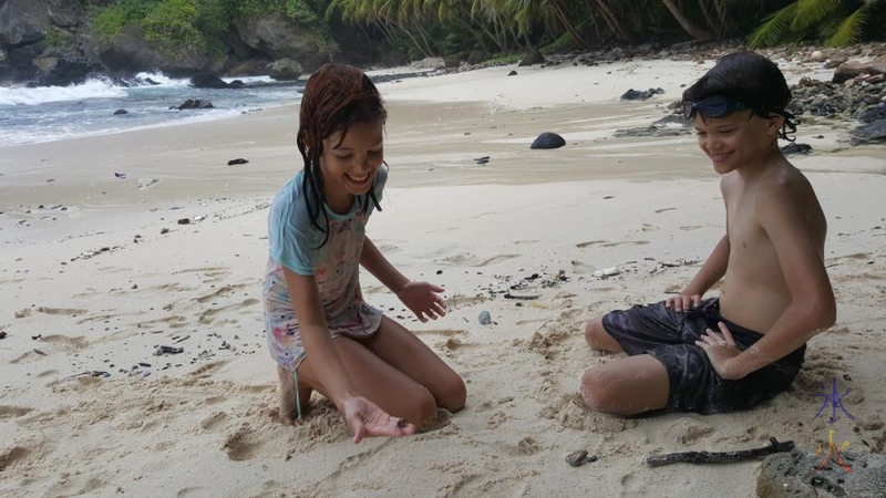 10yo squealing and carrying on while trying to hold a small crab at Dolly Beach, Christmas Island