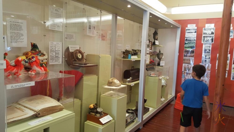 8yo looking at one of the main displays at Tai Jin House, Christmas Island