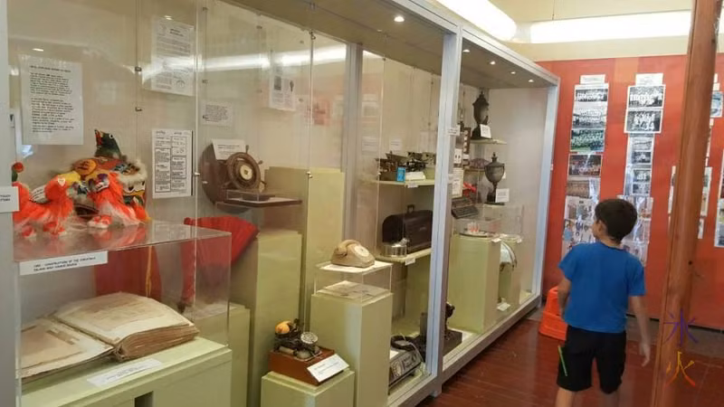 8yo looking at one of the main displays at Tai Jin House, Christmas Island