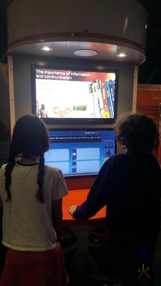 13yo and 11yo playing a multichoice game at SciTech, Perth, Western Australia