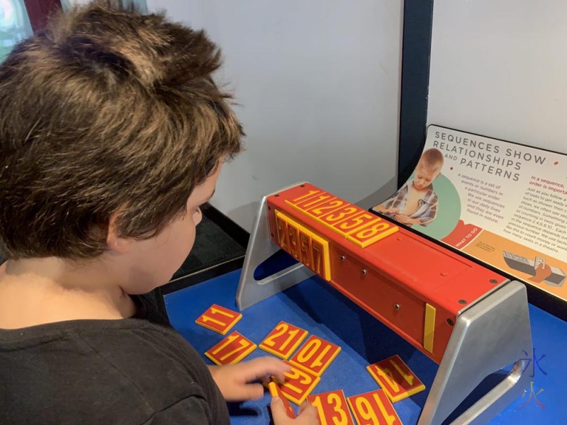 10yo working out number patterns at Scitech, Perth, Western Australia