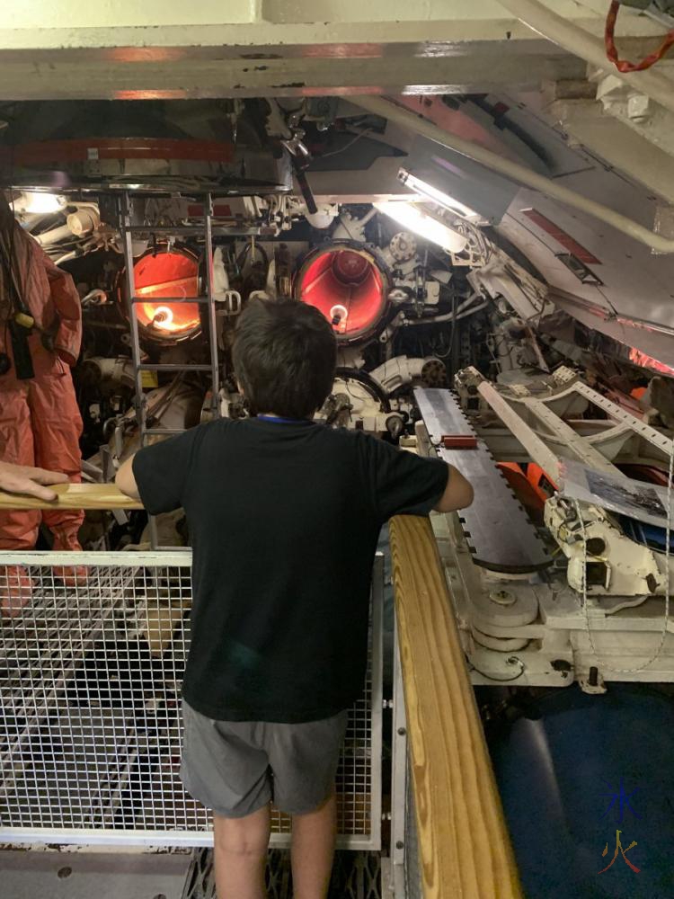 10yo looking at torpedo chutes on board HMAS Ovens, Maritime Museum, Fremantle, Western Australia