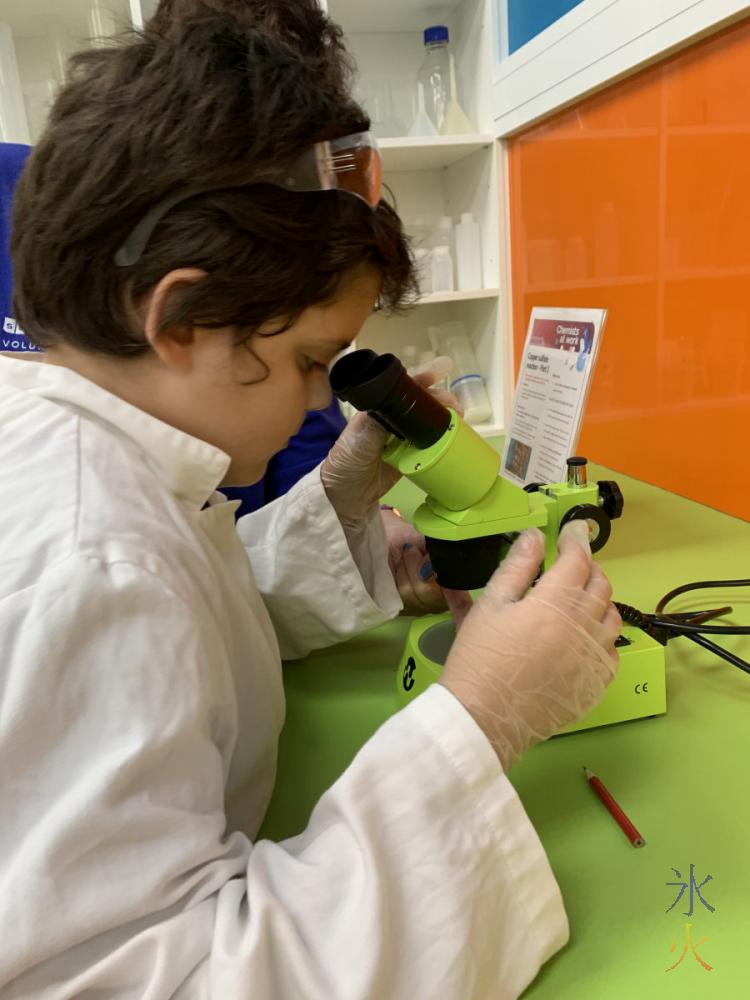 10yo looking through microscope in geochemistry unit at Scitech, Perth, Western Australia