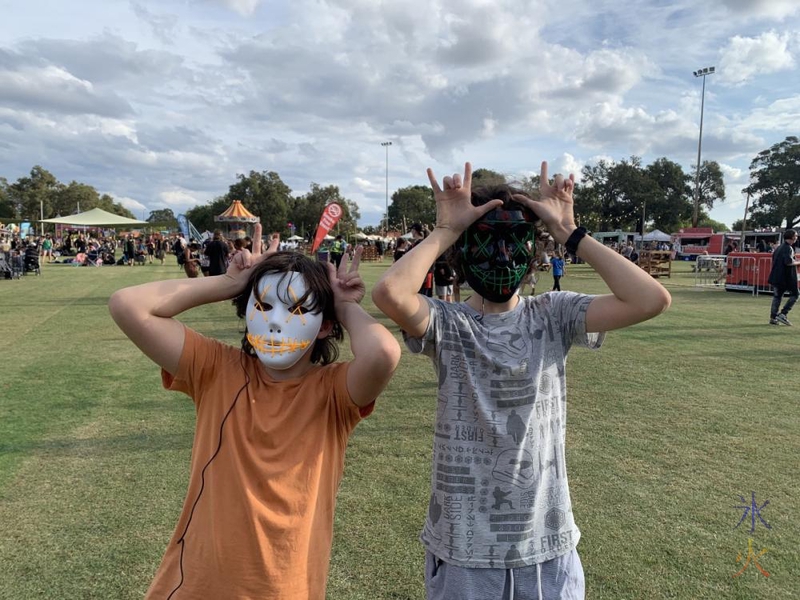 boys doing neko neko ne in light up Purge masks at Illuminate