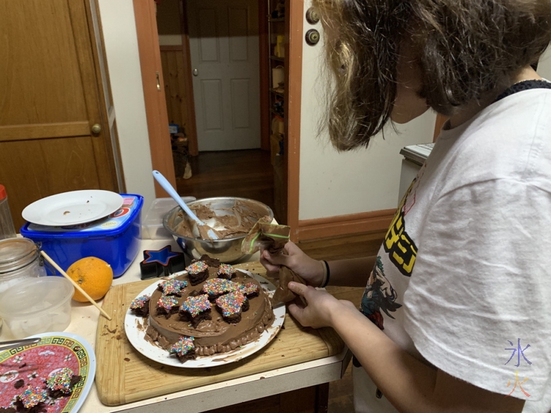 13yo finishing off the cake with some decorative piping