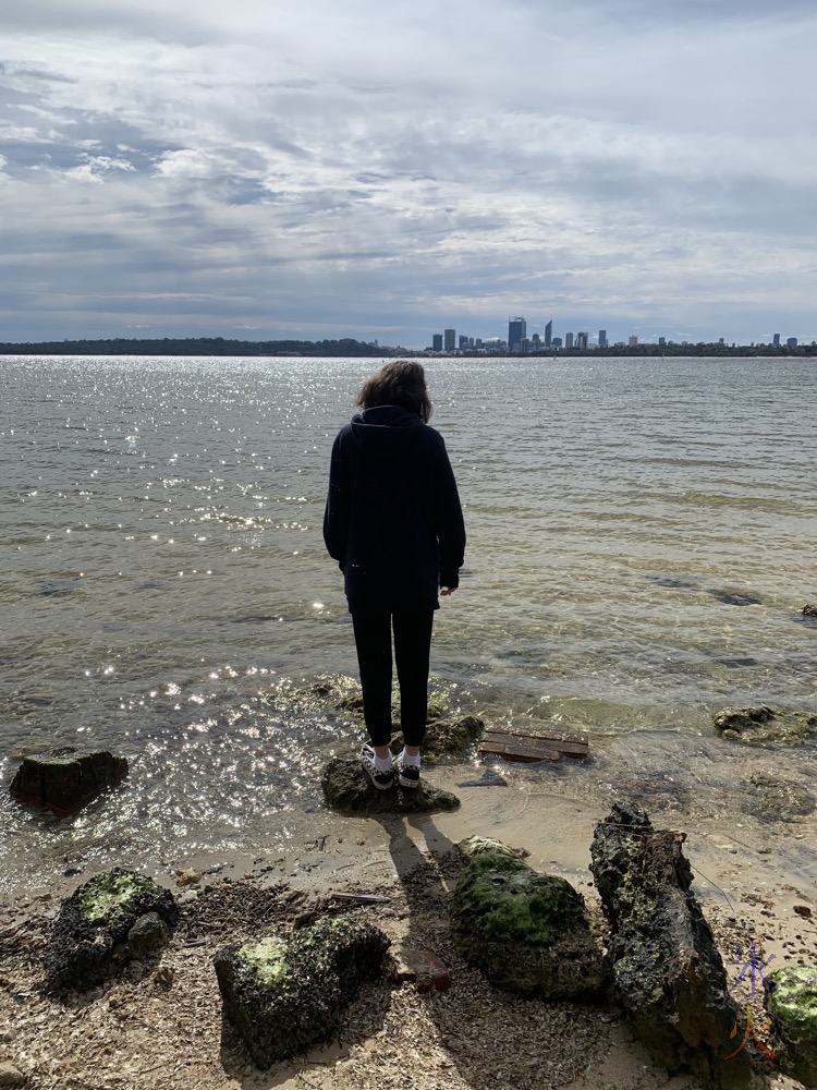 13yo balanced on rock looking out onto river, Applecross, Western Australia