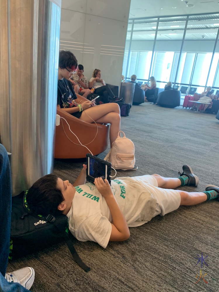 13yo and 11yo chilling near the boarding gate at Perth Airport, Western Australia