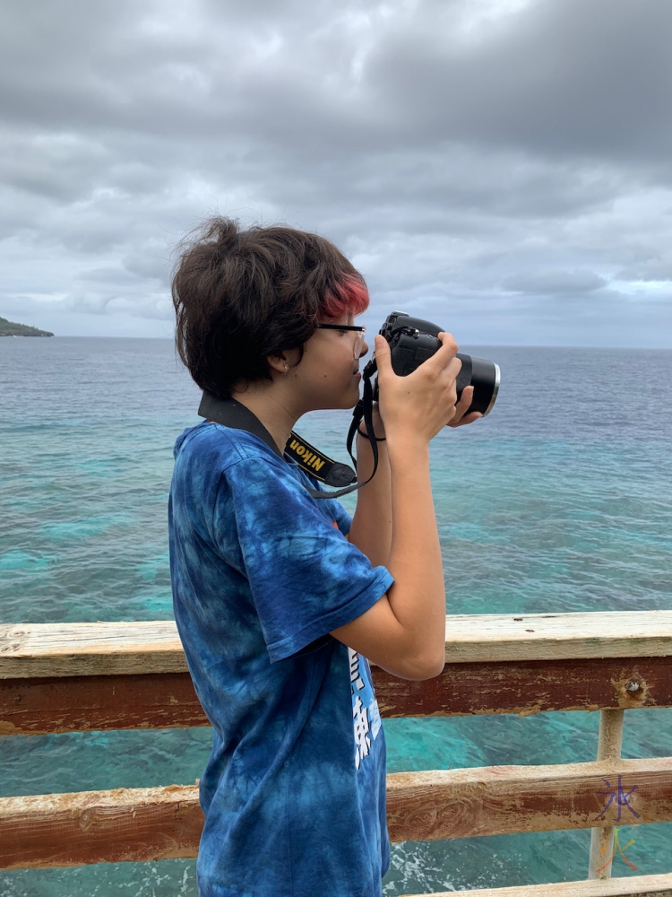 13yo figuring out DSLR 'upstairs' at Lily Beach, Christmas Island