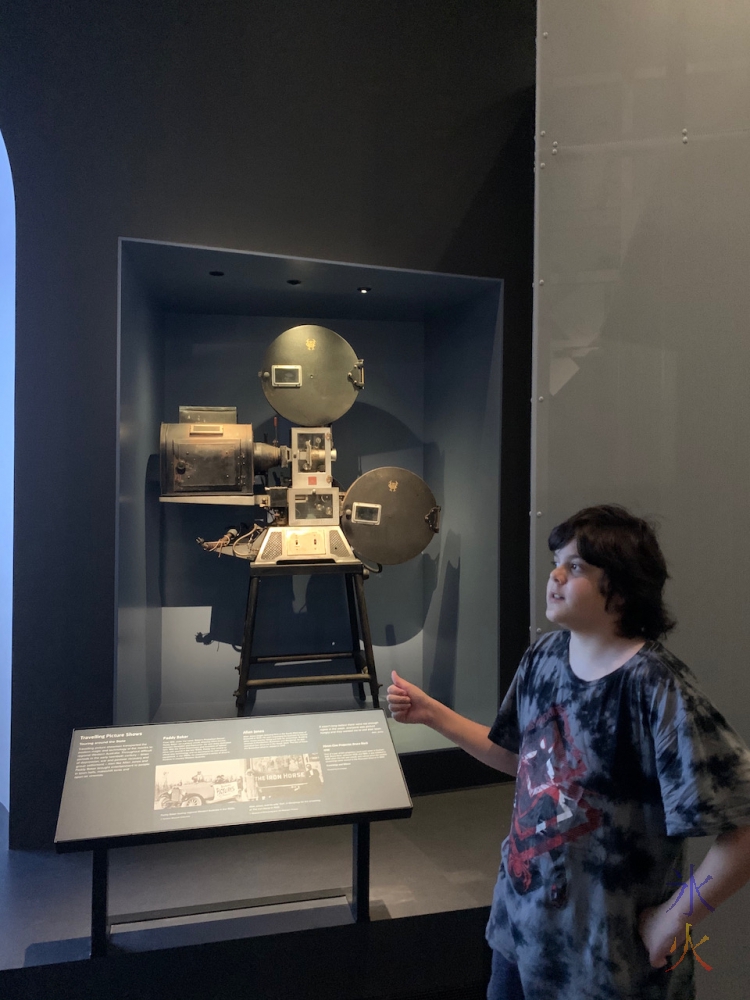 12yo looking at old film camera