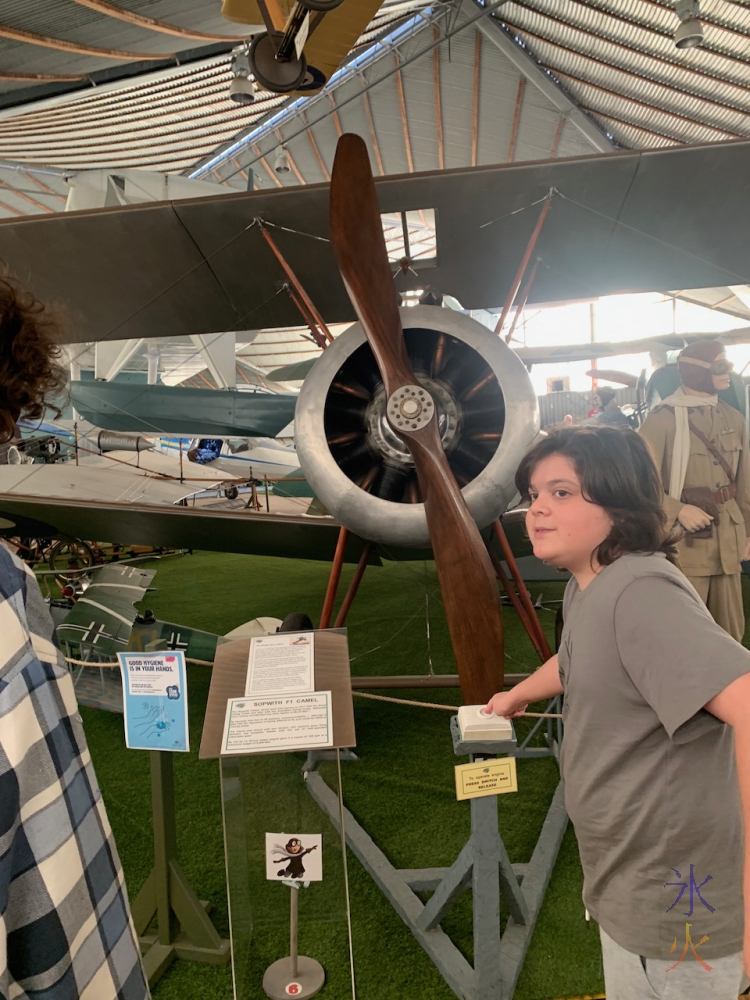 12yo pushing a button to make a propellor turn at Aviation Heritage Museum, Bull Creek, Western Australia