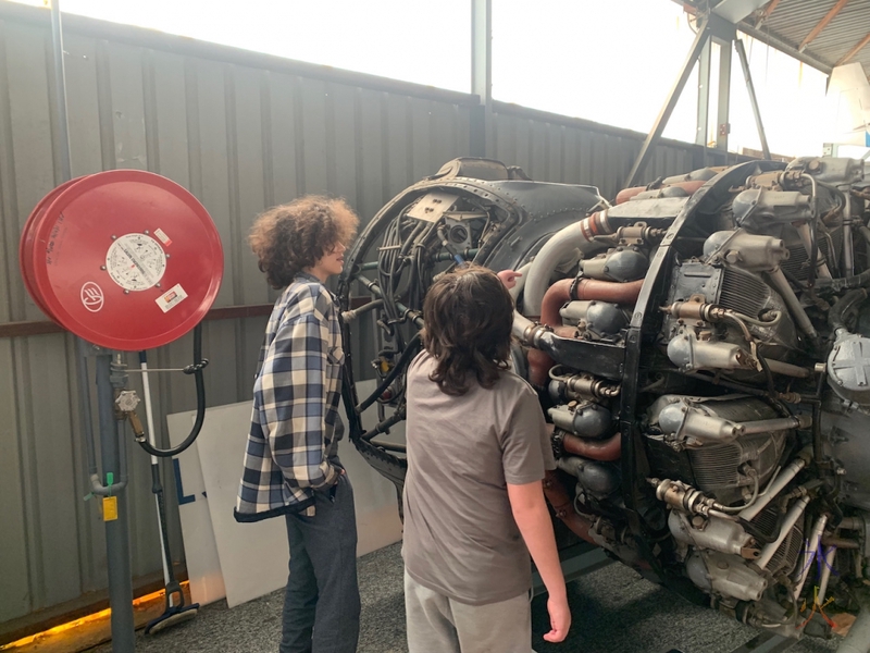 16yo and 12yo discussing plane engine at Aviation Heritage Museum, Bull Creek, Western Australia