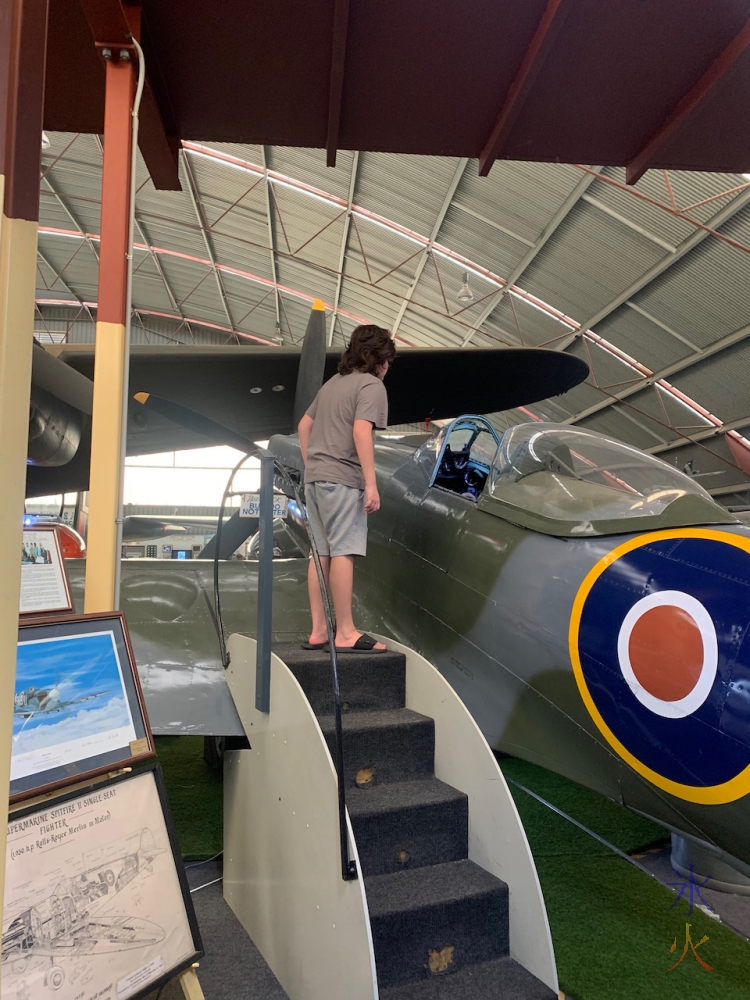 12yo looking into plane cockpit at Aviation Heritage Museum, Bull Creek, Western Australia