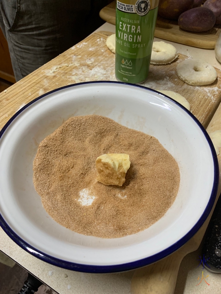 doughnut piece dipped in cinnamon mix because forgot to oil it