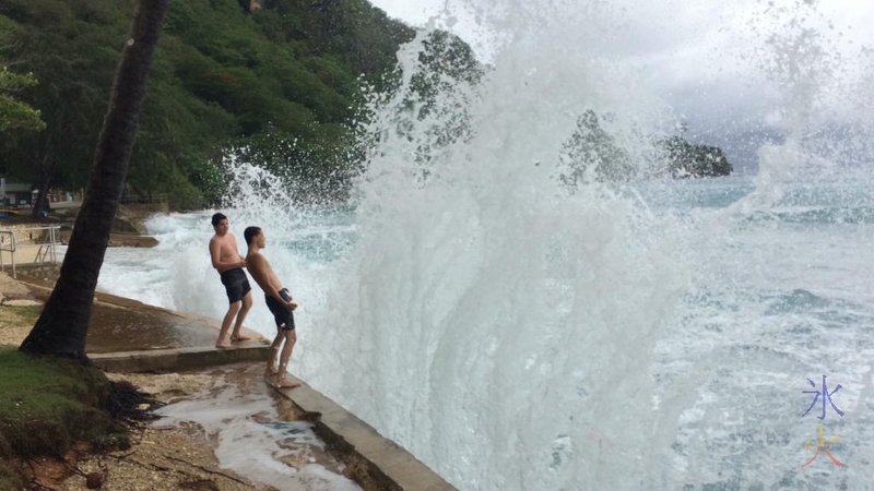 Boys getting splashed by some decent sized waves at Flying Fish Cove, Christmas Island