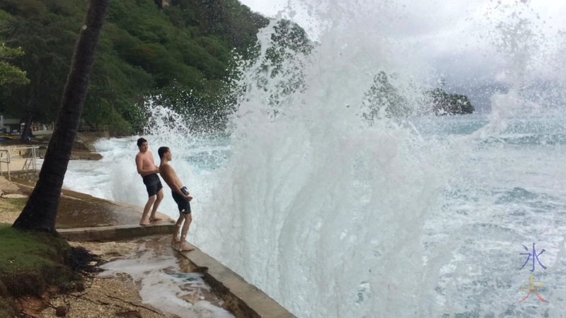 Boys getting splashed by some decent sized waves at Flying Fish Cove, Christmas Island