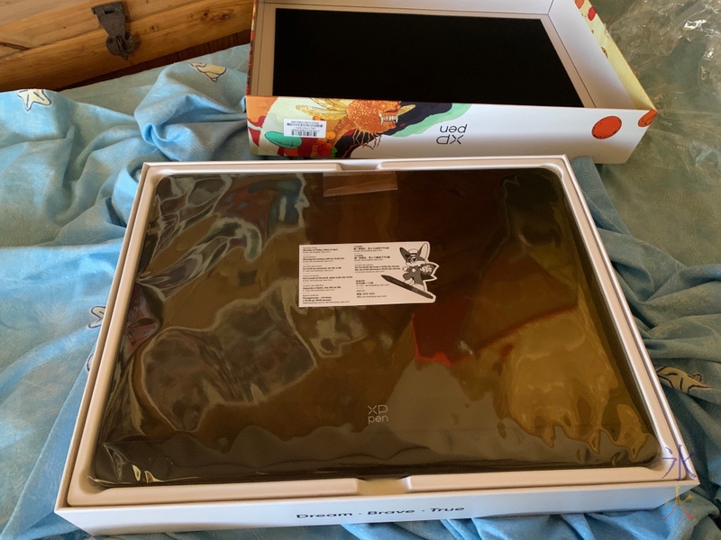 Opened XP-Pen Artist Pro 14 Gen2 box showing tablet in plastic sleeve on top