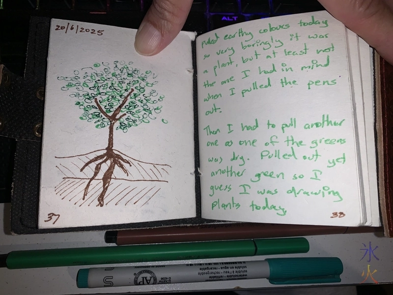 fineliner sketch of a tree on one page and thoughts on the opposing page in a tiny sketchbook journal