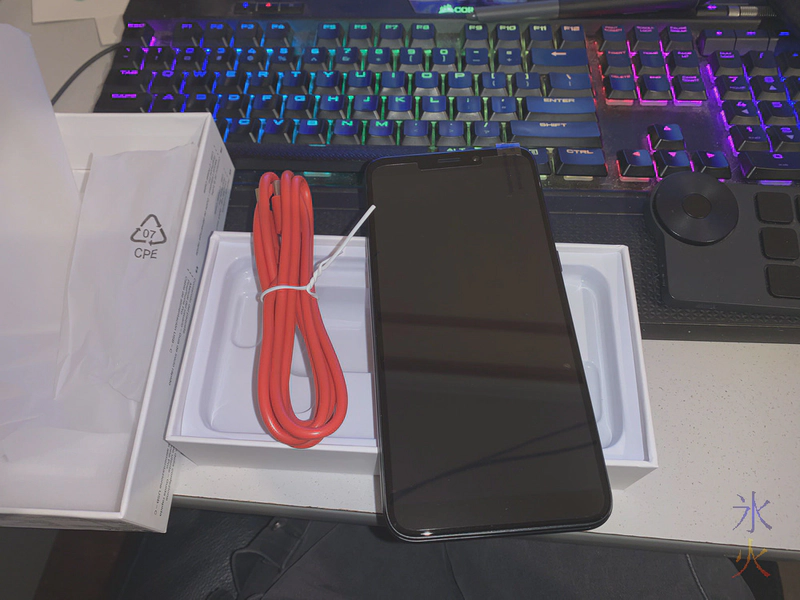 PinePhone Pro and bright red charge cable sitting on top of PinePhone Pro box PinePhone Pro and bright red charge cable sitting on top of PinePhone Pro box