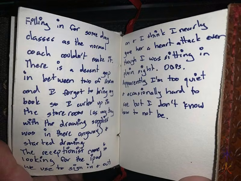 text scrawled in a tiny sketchbook